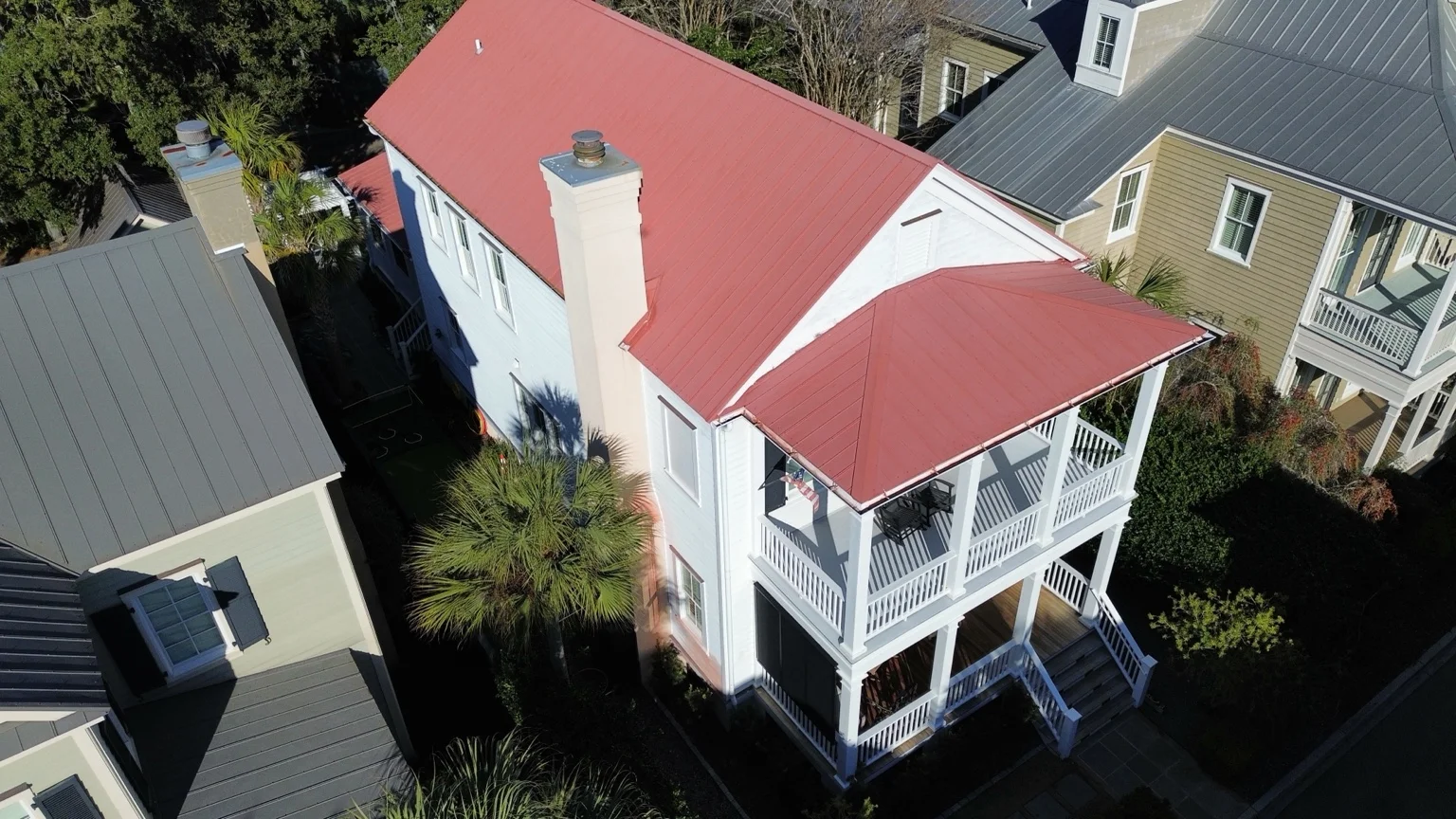 Lucky Dog project featuring a red metal roof on a white Lowcountry home